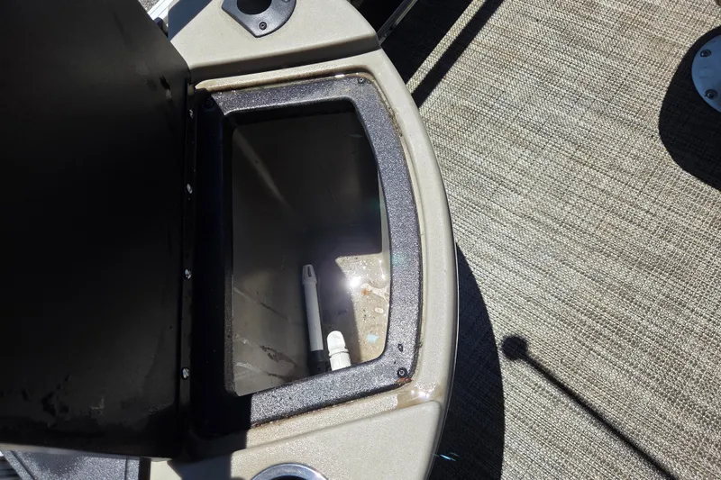 Slide: The Image of Open storage compartment on 2023 Ranger Reata 200F boat, featuring a clean interior and textured flooring. - 14