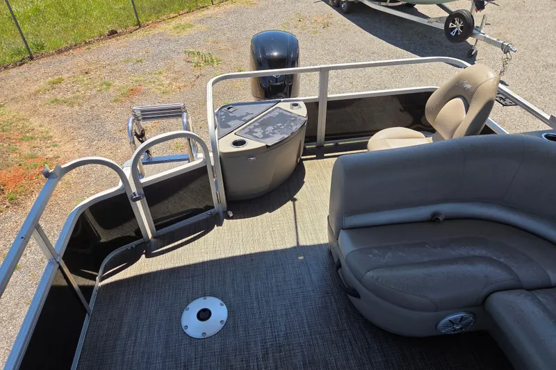Slide: The Image of 2023 Ranger Reata 200F pontoon boat interior with seating and ladder. - 15