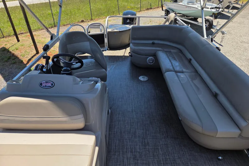 Slide: The Image of 2023 Ranger Reata 200F pontoon boat interior with spacious seating and steering console. - 16