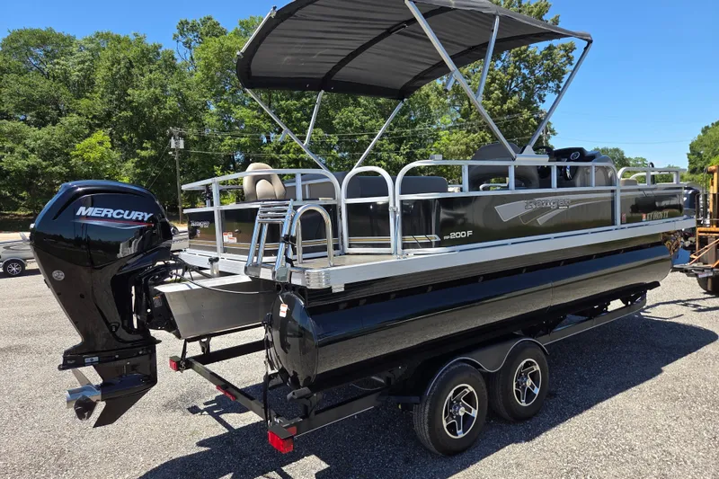 Slide: The Image of 2023 Ranger Reata 200F pontoon boat with Mercury outboard engine on trailer. - 4