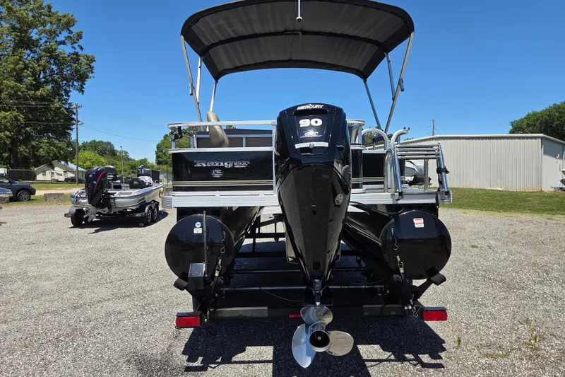 Slide: The Image of 2023 Ranger Reata 200F pontoon boat with Mercury 90 engine, parked outdoors. - 5