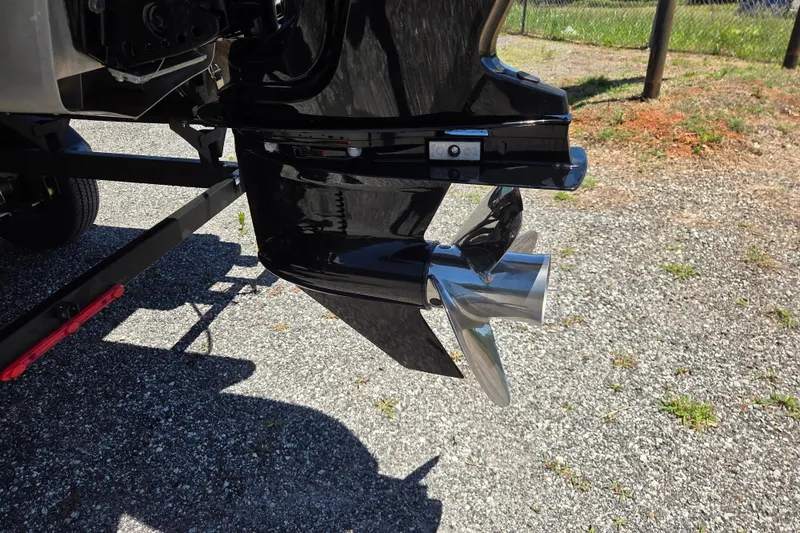 Slide: The Image of 2023 Ranger Reata 200F boat motor and propeller on gravel surface. - 6