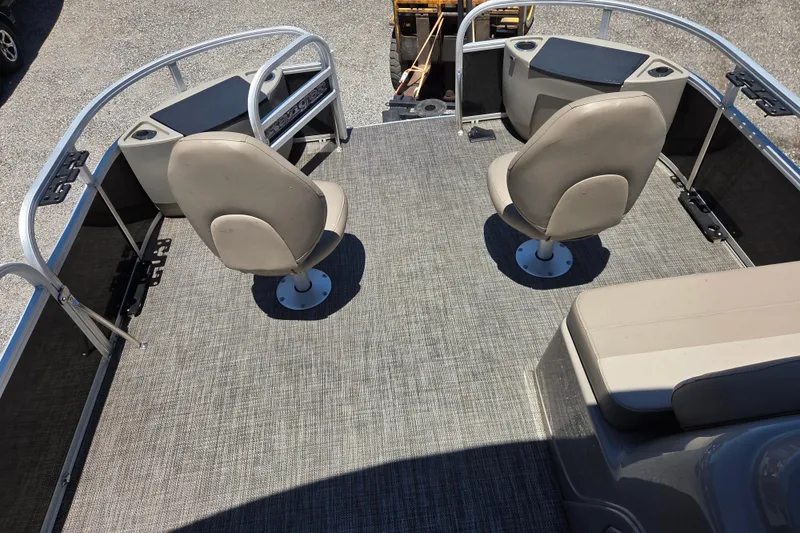 Slide: The Image of 2023 Ranger Reata 200F boat interior with two swivel seats and carpeted deck. - 7