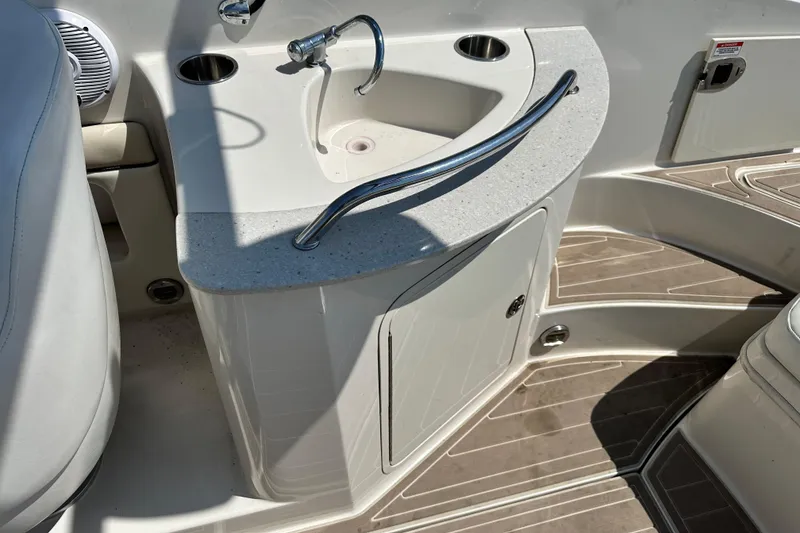 Slide: The Image of 2008 Sea Ray 260 Sundeck boat interior with sink and storage area. - 11