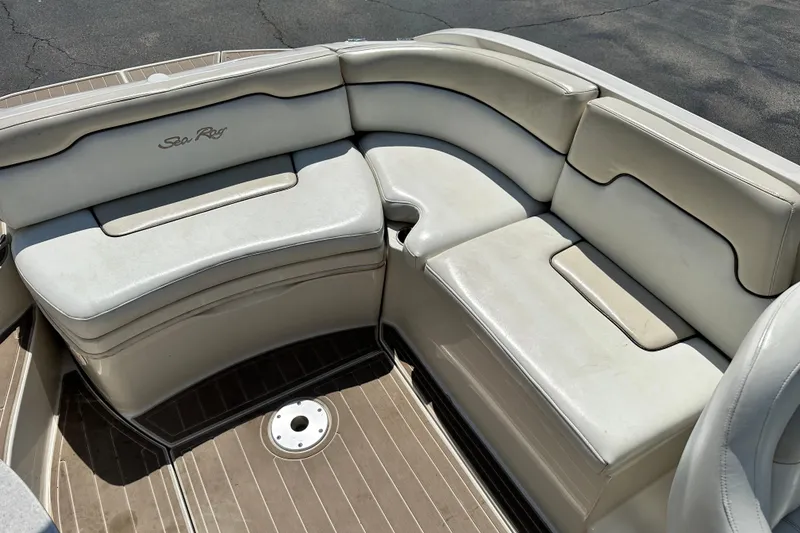 Slide: The Image of 2008 Sea Ray 260 Sundeck boat interior with white cushioned seating. - 12