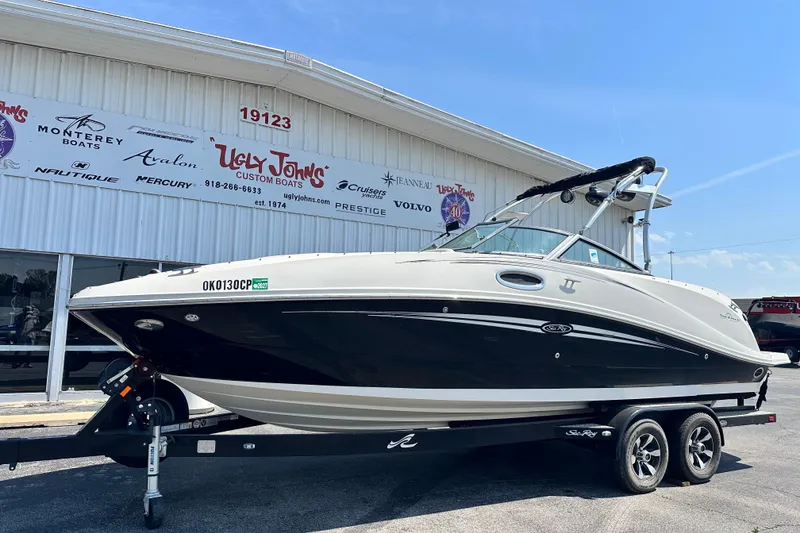 Slide: The Image of 2008 Sea Ray 260 Sundeck boat on trailer at Ugly John's Custom Boats dealership. - 2