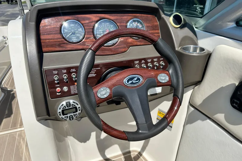 Slide: The Image of Steering wheel and dashboard of a 2008 Sea Ray 260 Sundeck boat. - 6
