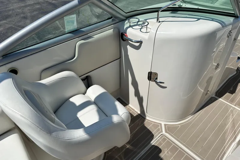 Slide: The Image of Interior of a 2008 Sea Ray 260 Sundeck boat, featuring a white captain's chair and dashboard. - 7