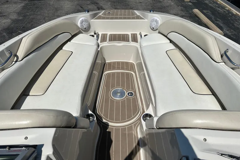 Slide: The Image of 2008 Sea Ray 260 Sundeck interior with beige seating and wood-style flooring. - 8