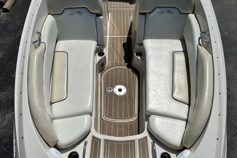 Slide: The Image of 2008 Sea Ray 260 Sundeck interior with white seating and wood-style flooring. - 9