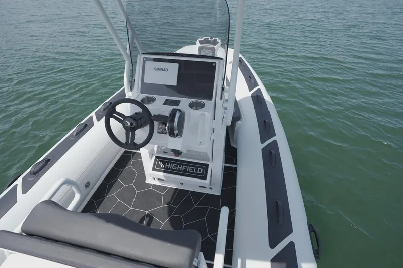 Slide: The Image of 2026 Highfield Sport 560 boat with modern console on calm water. - 14