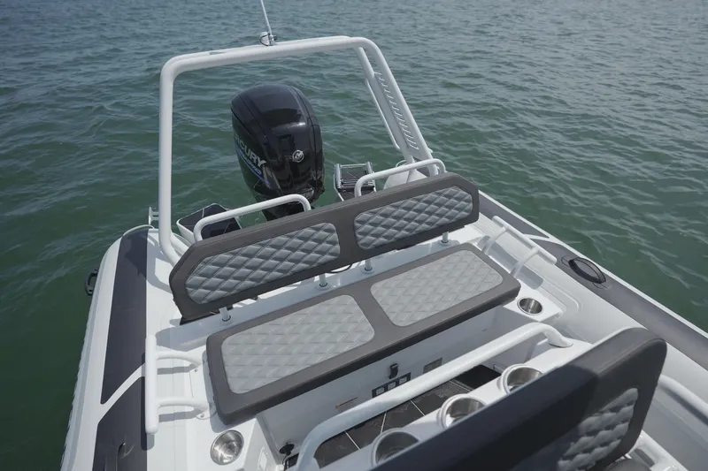 Slide: The Image of 2026 Highfield Sport 560 boat with cushioned seating and Mercury outboard motor on water. - 7