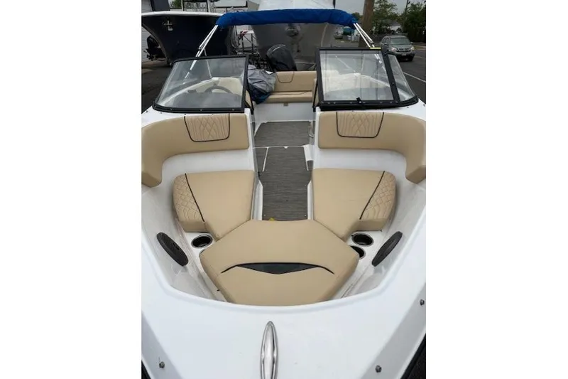 Slide: The Image of 2022 Glastron GX 210 Sport boat interior with beige seating and windshield. - 5