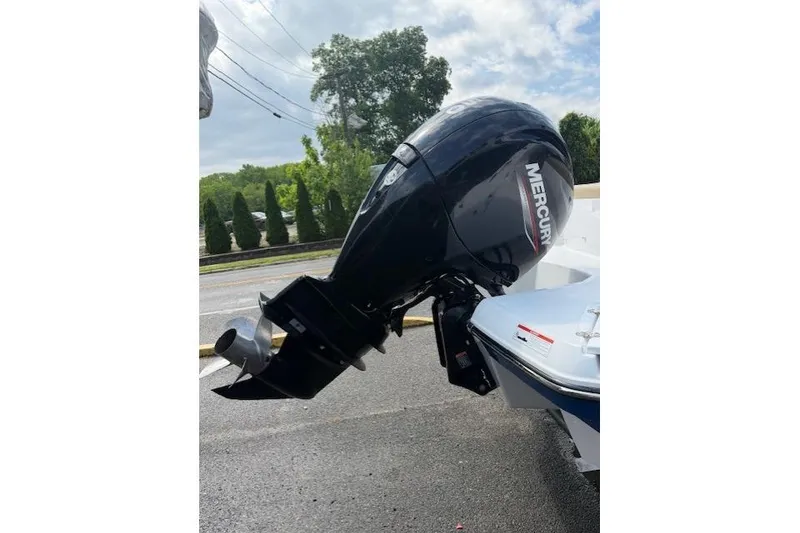 Slide: The Image of 2022 Glastron GX 210 Sport with Mercury outboard motor on a sunny day. - 6