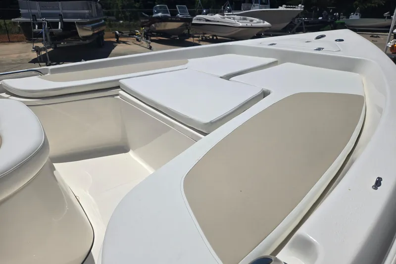 Slide: The Image of 2026 Bulls Bay 2000 boat interior with cushioned seating and storage compartments. - 12