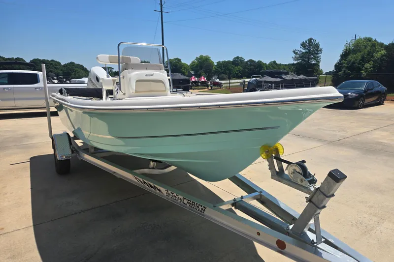 Slide: The Image of 2026 Bulls Bay 2000 boat on trailer, parked outdoors under clear blue sky. - 13