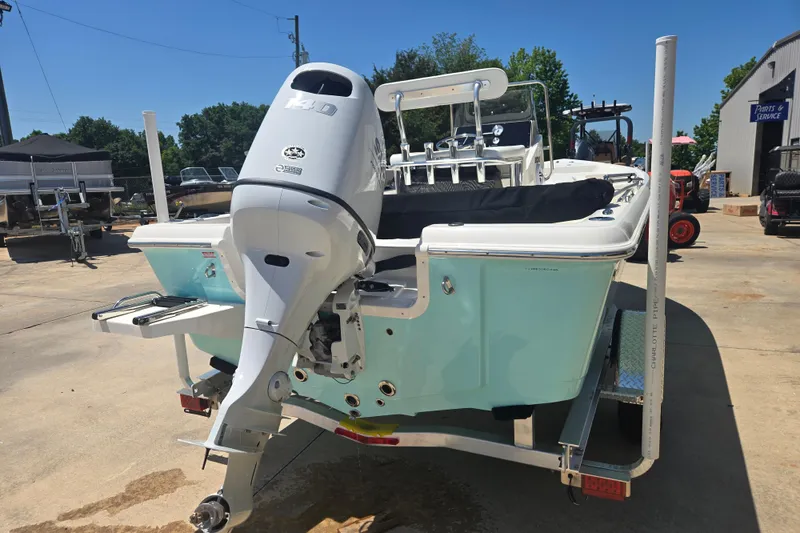 Slide: The Image of 2026 Bulls Bay 2000 boat with outboard motor on trailer, parked outdoors. - 16