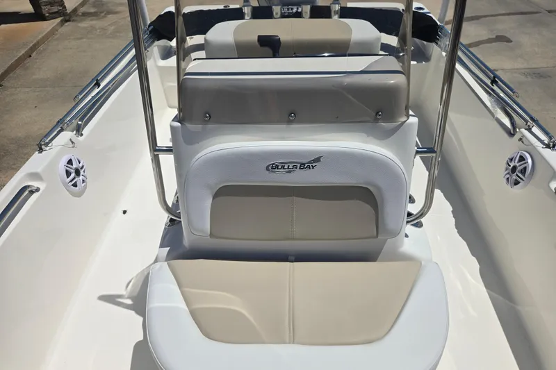 Slide: The Image of 2026 Bulls Bay 2000 boat interior with beige seating and branded logo. - 4