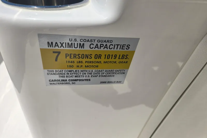 Slide: The Image of U.S. Coast Guard capacity label on 2026 Bulls Bay 2000 boat, 7 persons or 1019 lbs. - 6