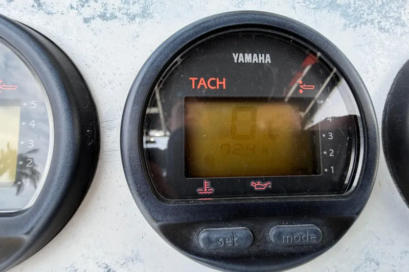 Slide: The Image of Yamaha tachometer on 2004 Triton 2895 CC boat dashboard, displaying engine RPM. - 23