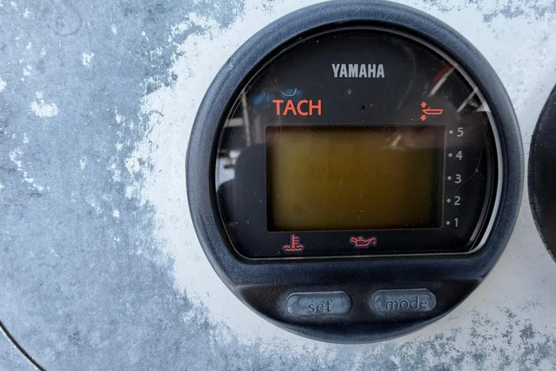 Slide: The Image of Yamaha tachometer on a 2004 Triton 2895 CC boat dashboard. - 24