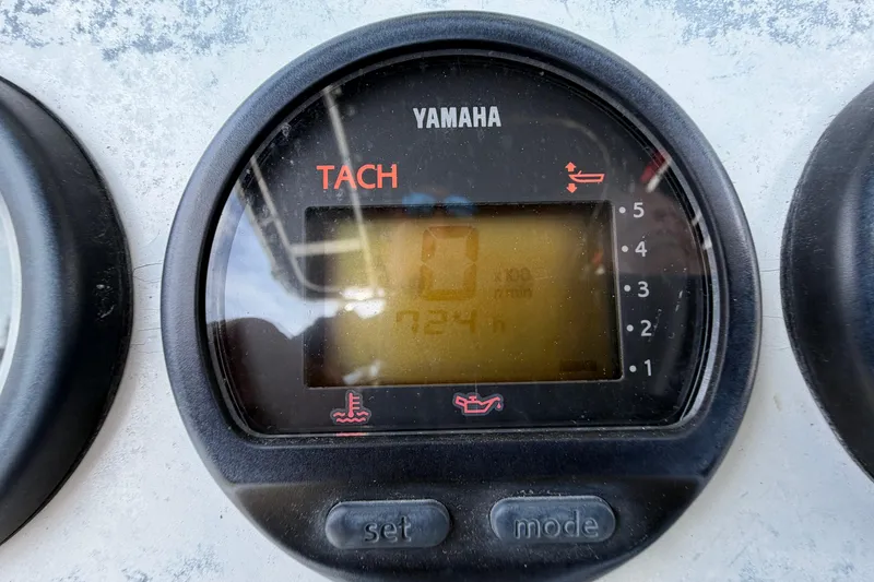 Slide: The Image of Yamaha tachometer on 2004 Triton 2895 CC boat dashboard, displaying zero RPM. - 25