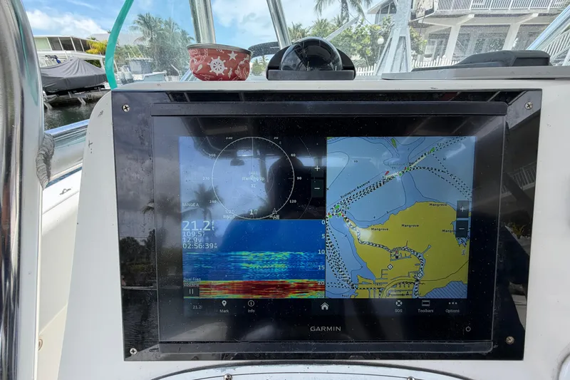 Slide: The Image of Garmin navigation display on 2004 Triton 2895 CC boat, showing maps and sonar data. - 26