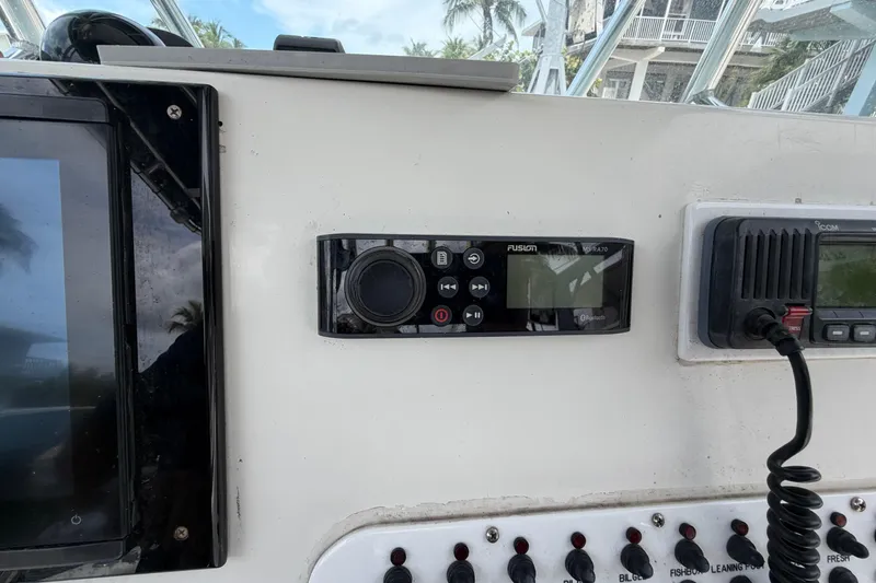 Slide: The Image of Control panel of a 2004 Triton 2895 CC boat with audio and communication systems. - 27