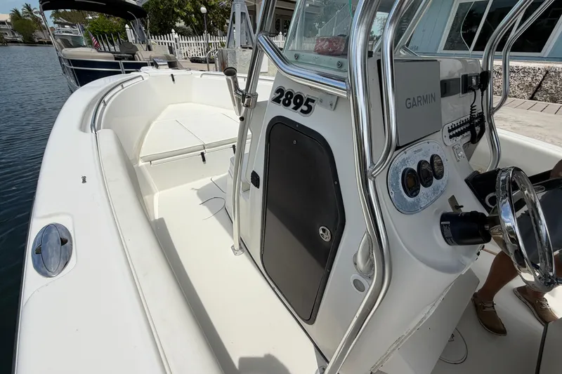 Slide: The Image of 2004 Triton 2895 CC boat interior with steering console and Garmin equipment. - 31
