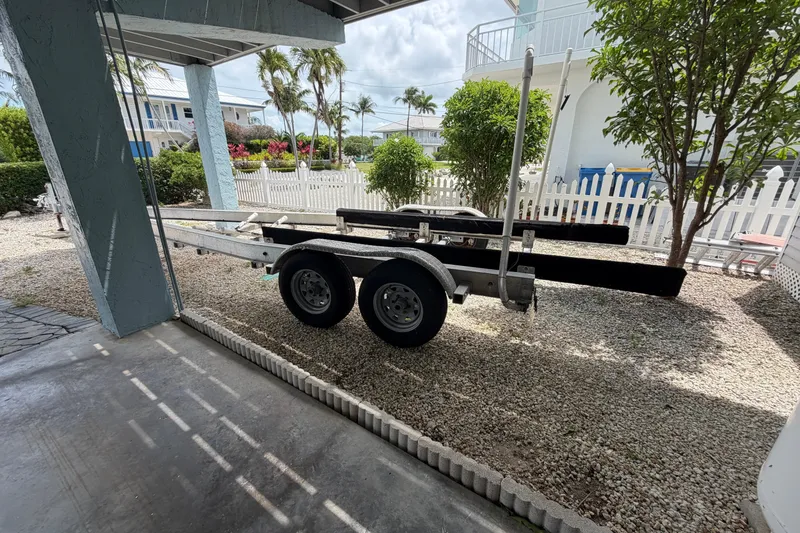 Slide: The Image of Boat trailer parked in a driveway, surrounded by tropical landscaping. - 35