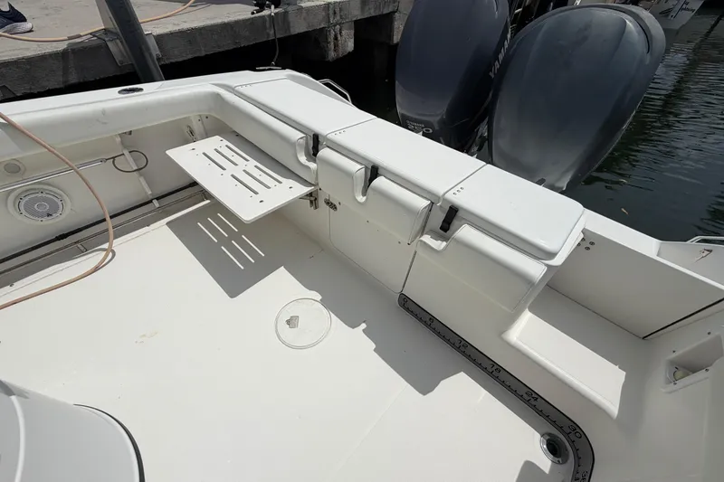 Slide: The Image of 2004 Triton 2895 CC boat interior with storage compartments and Yamaha outboard motors. - 8