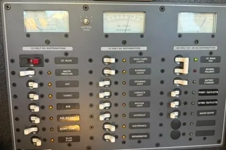 Slide: The Image of Electrical control panel of a 1985 Sabre 32 boat, featuring various switches and gauges. - 10