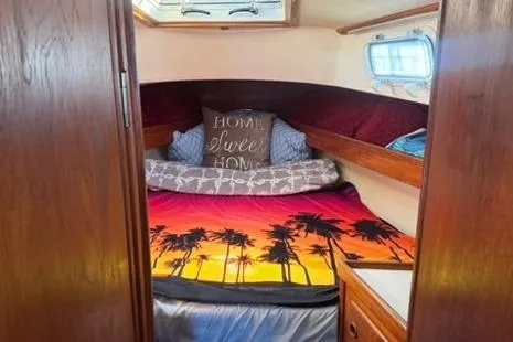 Slide: The Image of Cozy cabin interior of 1985 Sabre 32 sailboat with tropical-themed bedding. - 13