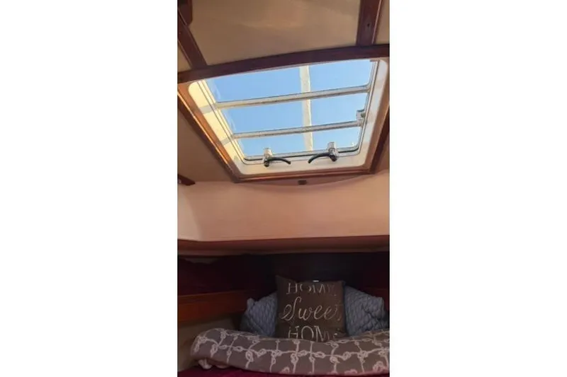 Slide: The Image of Interior cabin view of 1985 Sabre 32 sailboat with skylight and cozy bedding. - 14