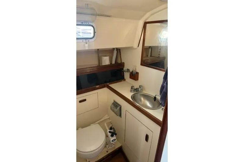 Slide: The Image of Compact bathroom in 1985 Sabre 32 sailboat with sink, toilet, and mirror. - 15