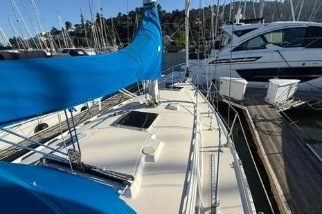 Slide: The Image of 1985 Sabre 32 sailboat with blue sail cover docked at marina. - 22