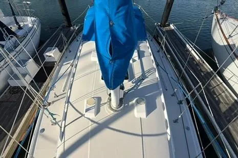 Slide: The Image of 1985 Sabre 32 sailboat deck with blue sail cover, docked at marina. - 24
