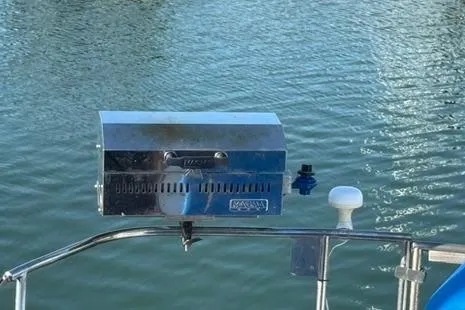 Slide: The Image of Stainless steel grill mounted on a 1985 Sabre 32 sailboat, overlooking calm water. - 26
