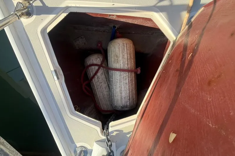 Slide: The Image of Storage compartment on a 1985 Sabre 32 sailboat with two fenders inside. - 27