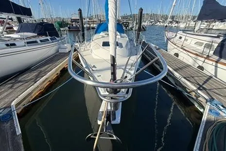 Slide: The Image of 1985 Sabre 32 sailboat docked at marina, surrounded by other boats. - 3