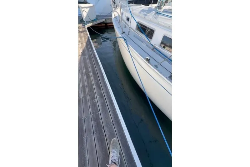 Slide: The Image of Docked 1985 Sabre 32 sailboat with blue ropes and wooden pier. - 30