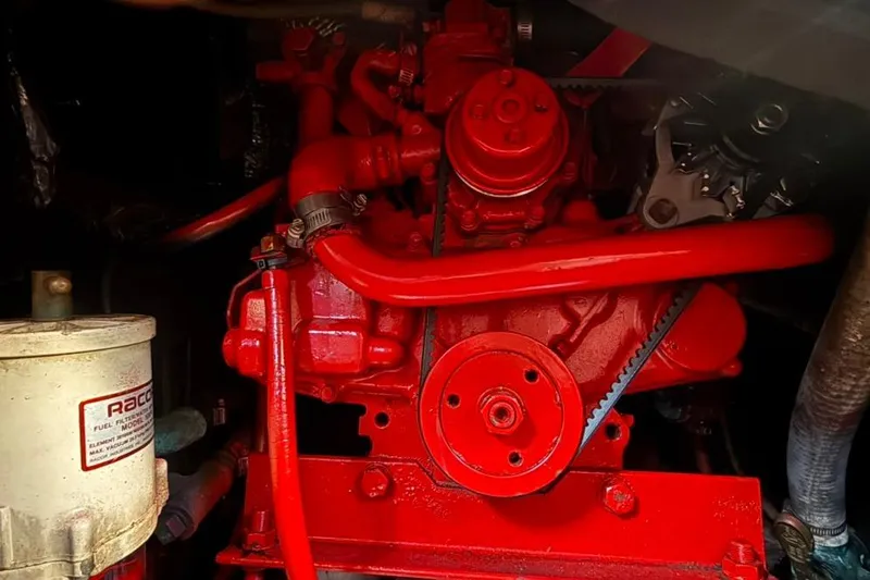 Slide: The Image of Red engine of a 1985 Sabre 32 sailboat with visible belts and components. - 37