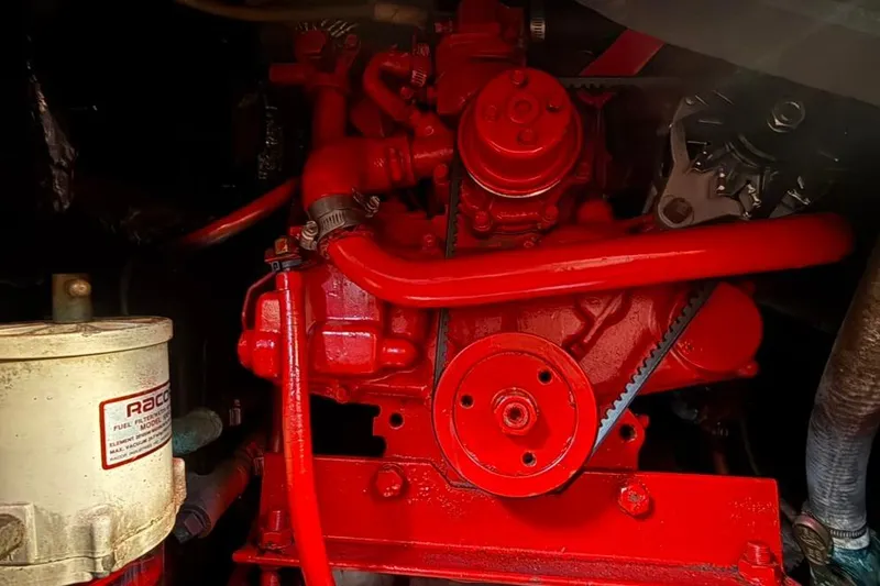 Slide: The Image of Red engine of a 1985 Sabre 32 boat, featuring visible belts and components. - 38