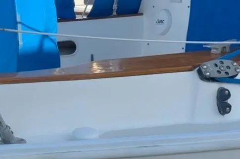 Slide: The Image of 1985 Sabre 32 sailboat cockpit with blue seating and wooden trim. - 40