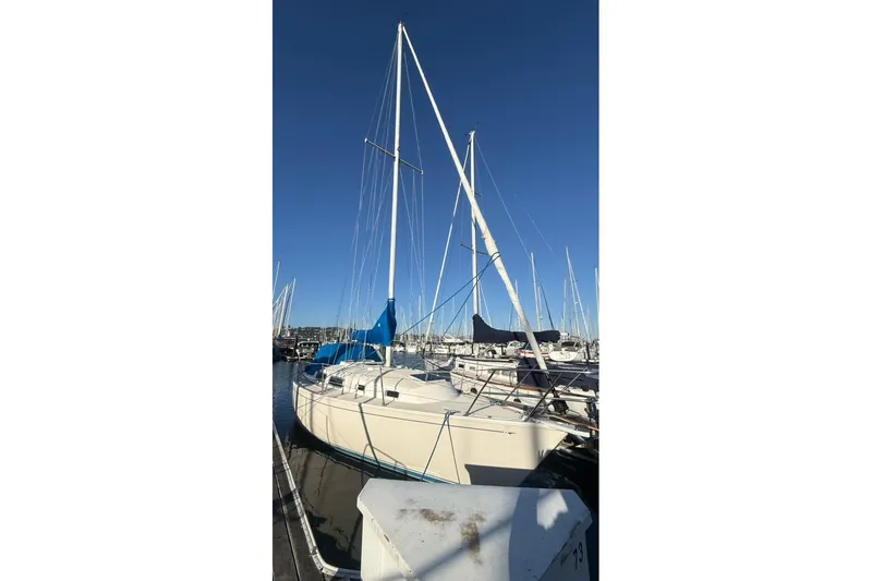 Slide: The Image of 1985 Sabre 32 sailboat docked at marina under clear blue sky. - 43