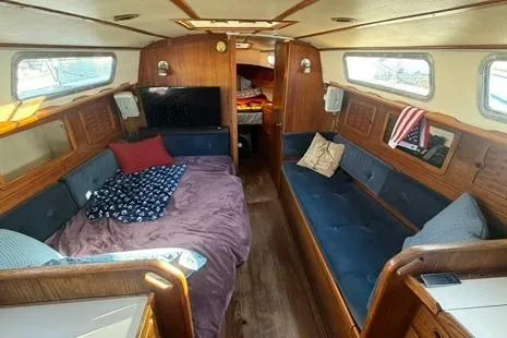 Slide: The Image of 1985 Sabre 32 sailboat interior with cozy seating, wooden finish, and nautical decor. - 8