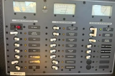 Slide: The Image of Electrical control panel on a 1985 Sabre 32 boat, featuring various switches and gauges. - 9