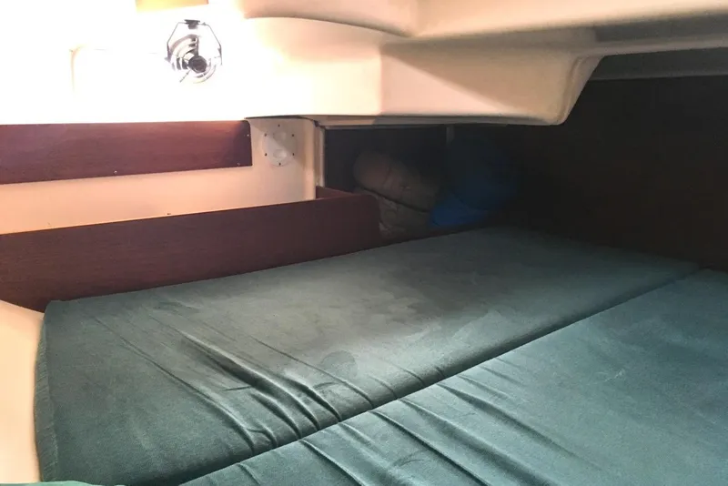 Slide: The Image of Cozy cabin interior of 1996 Beneteau Oceanis 321 sailboat with green bedding. - 13