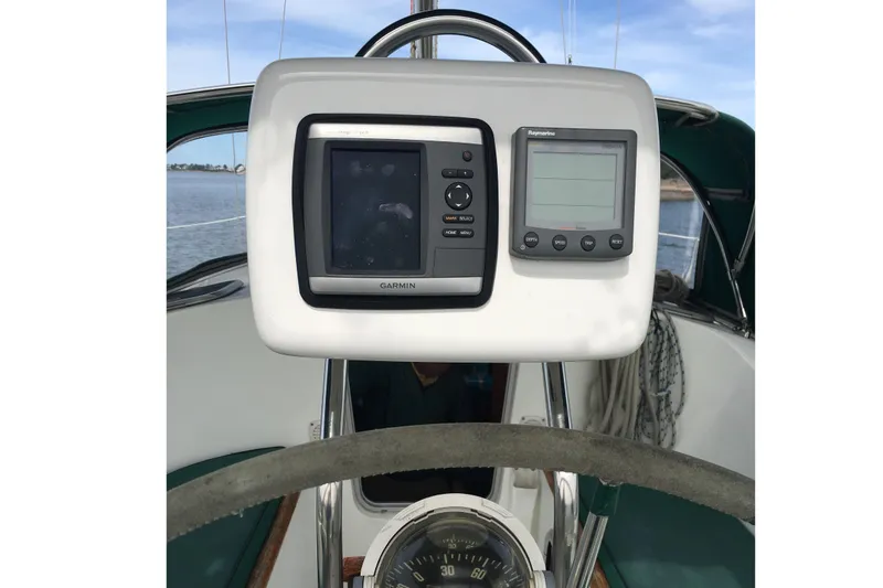 Slide: The Image of Cockpit of 1996 Beneteau Oceanis 321 with Garmin and Raymarine navigation displays. - 14