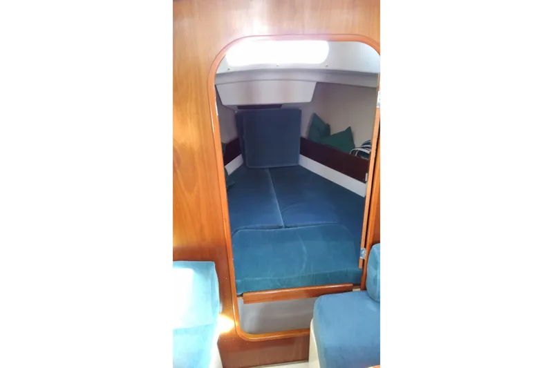 Slide: The Image of Interior cabin of a 1996 Beneteau Oceanis 321 sailboat with blue cushions. - 15
